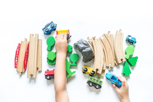 istock Wooden railway. A boy plays a toy train. Flat lay. 1305914664