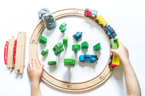 istock Wooden railway. A boy plays a toy train. Flat lay. 1305914675