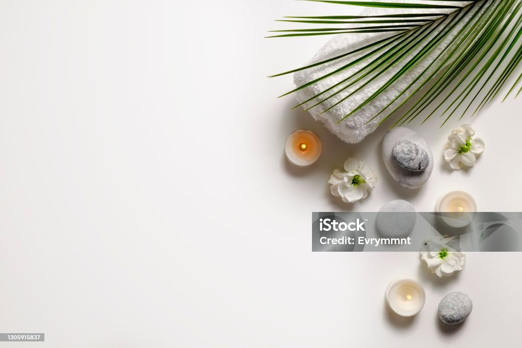 Cosmetic products on textured background. Composition with symbolic objects for spa salon. Stone therapy attributes for cosmetic procedures. Conceptual image, rocks and flowers representing balance. Close up, copy space, top view, background. Alternative Therapy Stock Photo Cosmetic products on textured background. Composition with symbolic objects for spa salon. Stone therapy attributes for cosmetic procedures. Conceptual image, rocks and flowers representing balance. Close up, copy space, top view, background. Alternative Therapy Stock Photo