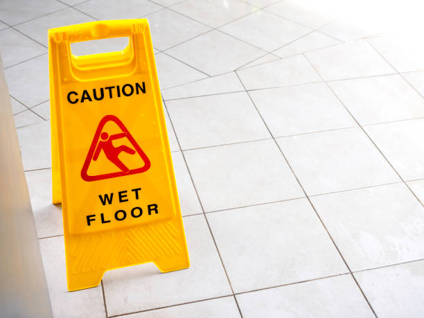 istock Wet floor caution sign on walkway near the building after raining. 1305917066