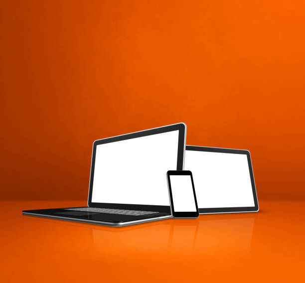 istock Laptop, mobile phone and digital tablet pc on orange office desk 1305917280