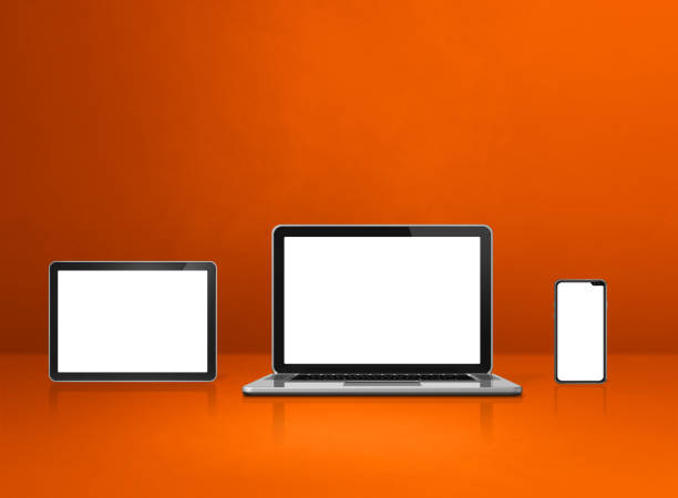 istock Laptop, mobile phone and digital tablet pc on orange office desk 1305917296