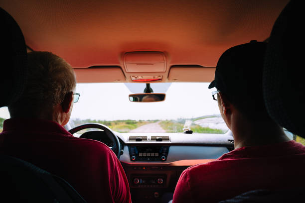 istock Rear View Of Man Driving Car 1305919242