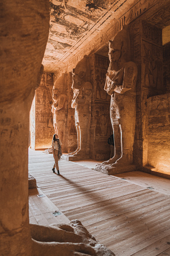 Young Caucasian woman walking inside  Abu Simbel temples