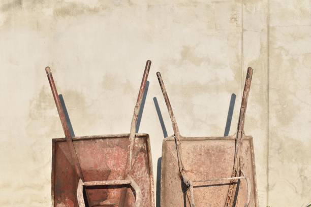 istock old Cement cart on construction site,wheelbarrow 1305924087