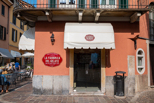 The ice cream shop called La Fabbrica del Gelato in Menaggio, Italy, with people in the background
