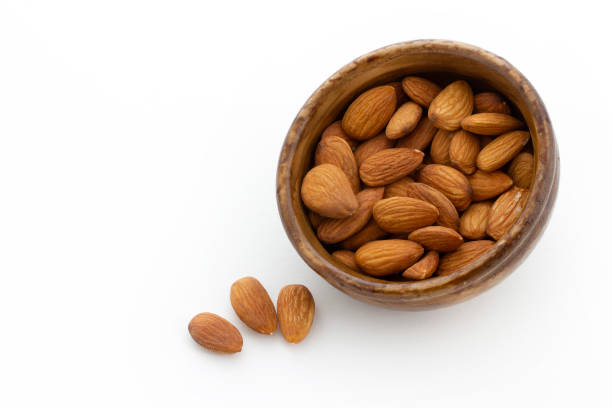 istock bamboo bowl of almonds on white background 1305926916