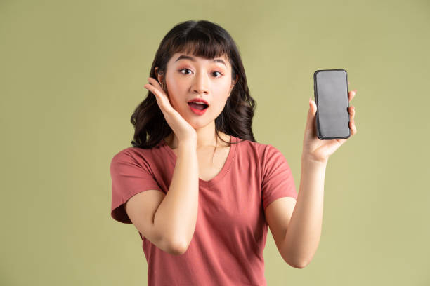 istock Woman holding smartphone 1305927007