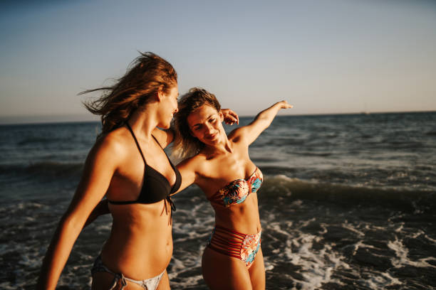 istock Cheerful friends enjoying day on the beach 1305927310