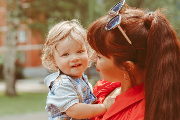 istock mom holds her son in her arms 1305927985
