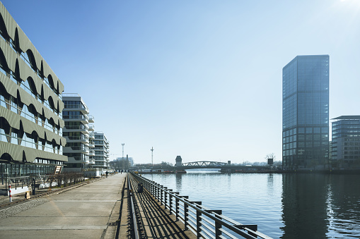 promenade at spree river in modern business and residential district in berlin, Elsenbrücke in the background