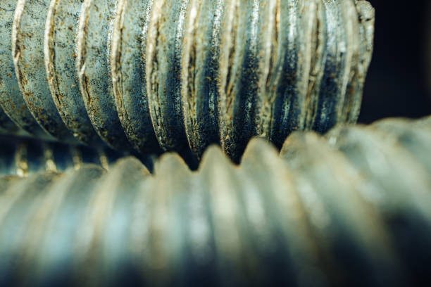 Many metal screws on concrete close up, macro