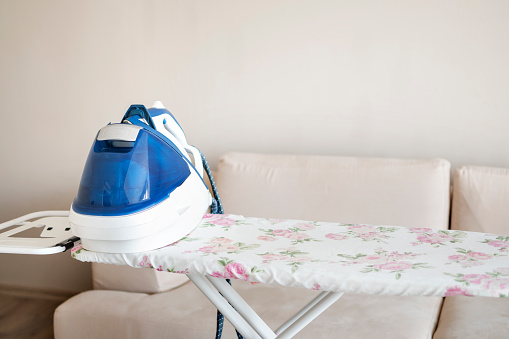 An ironing board with an iron to living room
