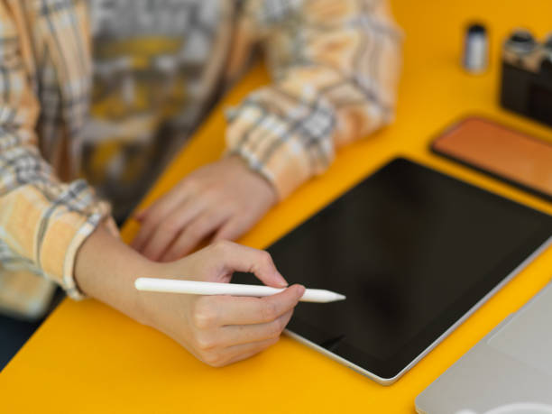 istock Female freelancer working on digital tablet with stylus pen on stylish workspace 1305929705