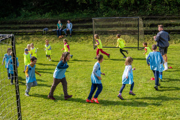 istock Children doing warm up exercise on soccer field 1305931962
