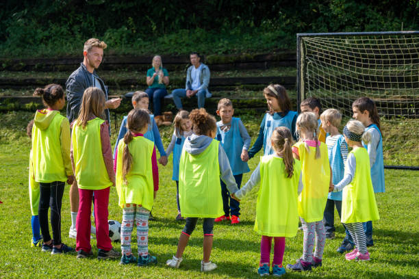 istock Children doing warm up exercise on soccer field 1305932020