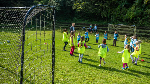 istock Children doing warm up exercise on soccer field 1305932100