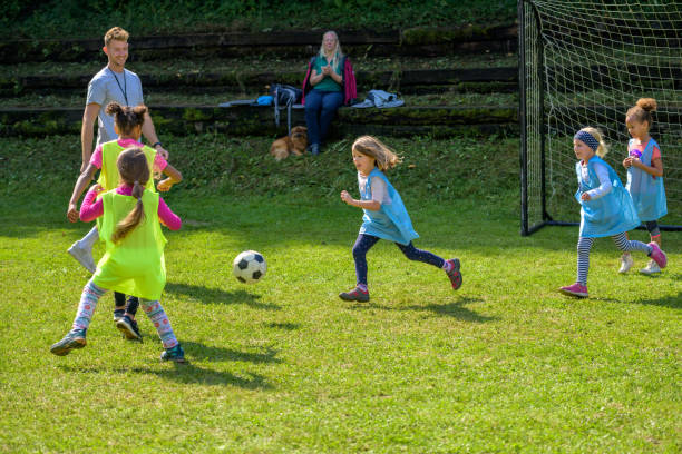 istock Girls playing match on soccer field 1305932249