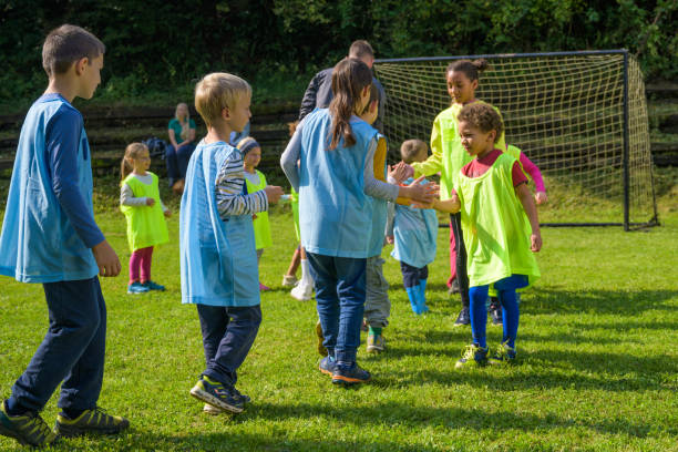 istock Children giving high-five to opposite team before match 1305932966
