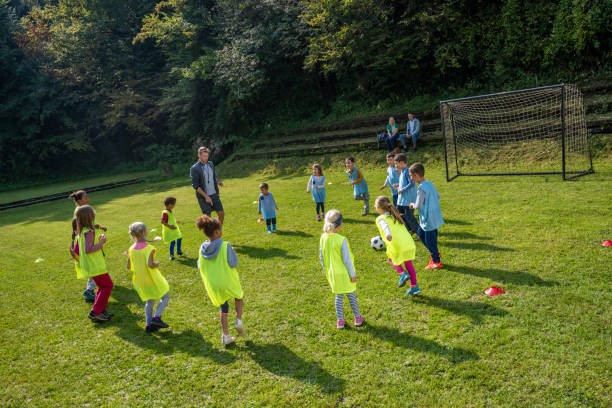 istock Children and coach playing match 1305933601