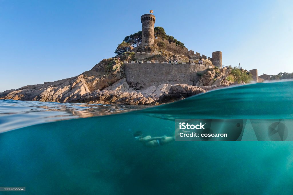 Little boy snorkeling with a castle in the background Half Full Stock Photo