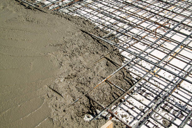 istock pouring concrete into prepared place with reinforced metal frame 1305936365