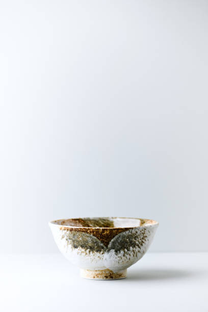 istock Traditional ceramic bowl on bright paper background. Soft focus. Copy space. 1305937795