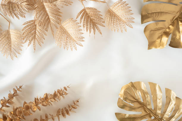 istock Gold tropical palm leaves Monstera on white background. Flat lay 1305937947