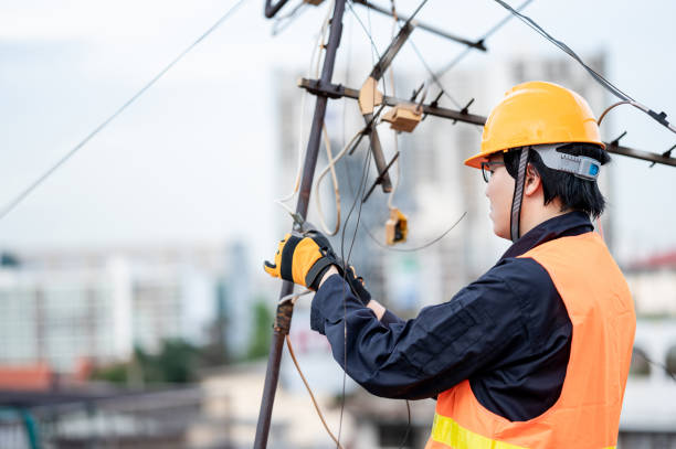 istock Asian worker repairing an old TV antenna on rooftop 1305939743