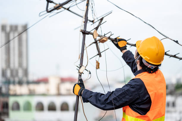 istock Asian worker repairing an old TV antenna on rooftop 1305939748