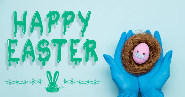 happy easter holiday safety hands egg face in mask - easter text single word paint imagens e fotografias de stock