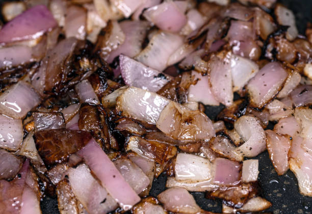 istock Fresh red onions fried in a pan 1305941905