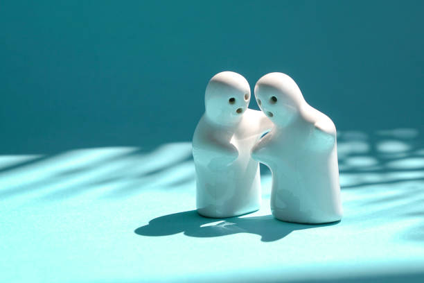 istock Two toy models consulting and talking to each other. 1305942130
