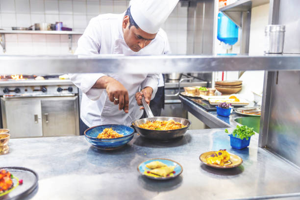 istock Professional Chef serving freshly cooked Chicken Biryani 1305943600