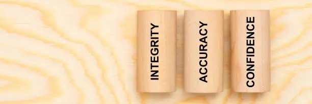 Photo of integrity, accuracy and confidence printed on three pillars