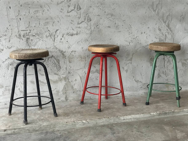 istock vintage old chair with concrete wall background 1305944755