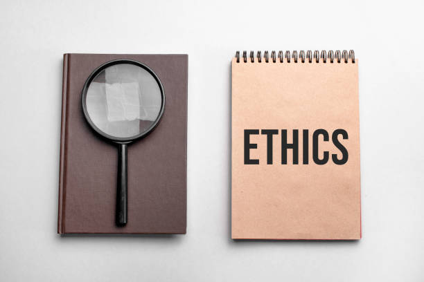 istock Craft colour notepad with text ETHICS. Notepad with , magnifying glass. Business concept 1305946090