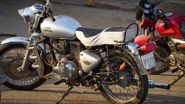 Classical Royal Enfield Bullet Electra 350 bike parked on the rough road. New modern bike closeup. stock photo