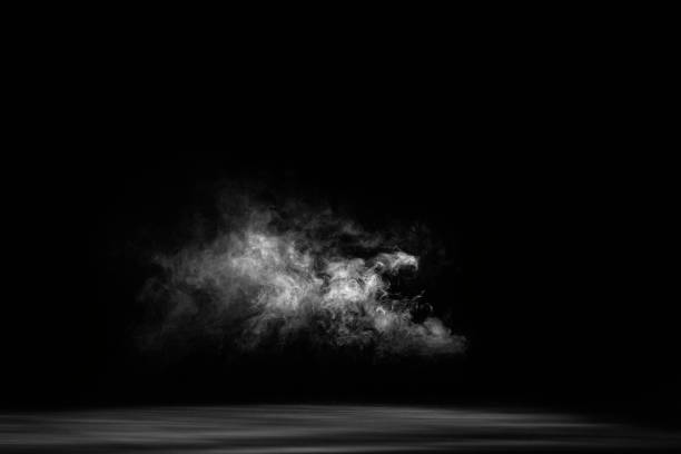 istock Dry white ice smoke clouds fog empty stage textured. Isolated black background. 1305947689