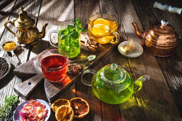 istock Tea and herbal infusion with dried herbs on wooden rustic table board 1305948568