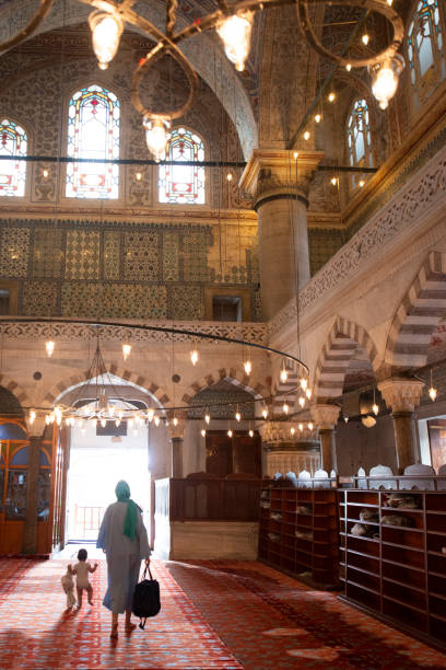 Interior of the Blue Mosque, Sultanahmet Mosque Istanbul, Turkey. Istanbul-Turkey - September, 11, 2016: People who visited and praying inside the Blue Mosque. Grandmother and grandson turkey koran people design stock pictures, royalty-free photos & images