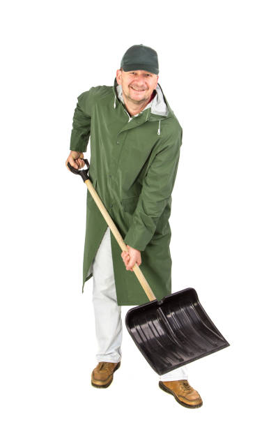 istock Man in long vest with shovel. 1305950184