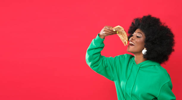istock Pizza lover - young black woman. 1305950225