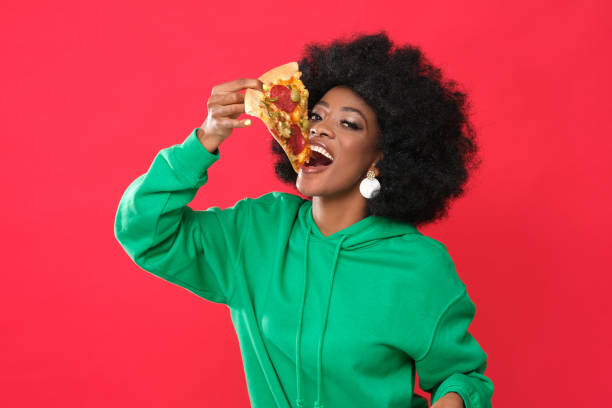 istock Pizza lover - young black woman. 1305950248