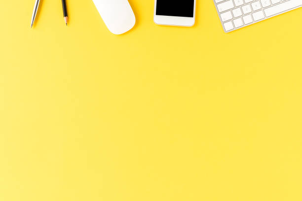 istock Office desktop with accessories on yellow table. Business background 1305950326