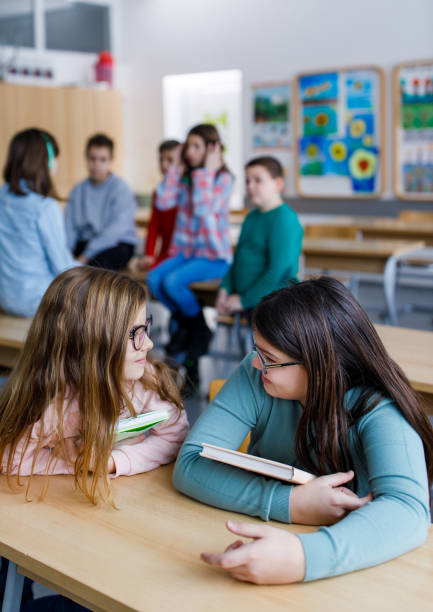 istock Girls talking in the classroom 1305951071