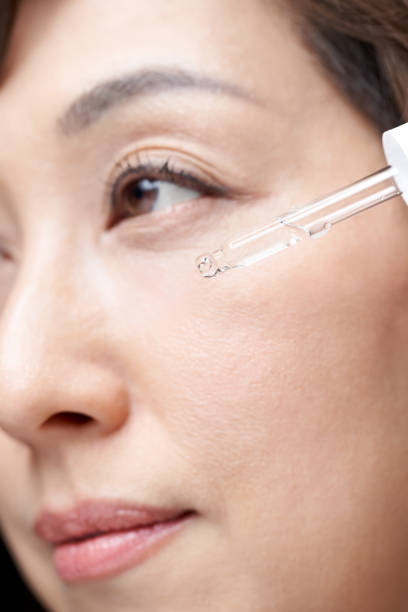 istock Middle-aged Japanese woman dripping serum on her face 1305951190