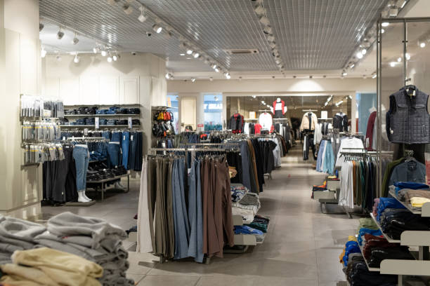 istock Clothing on shelfs in store 1305951334