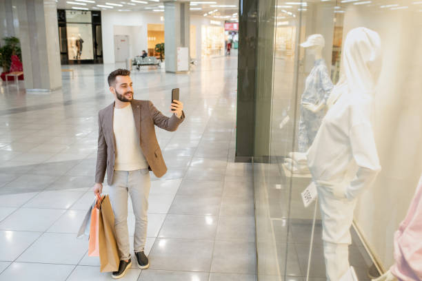 istock Man doing shopping in the mall 1305951366