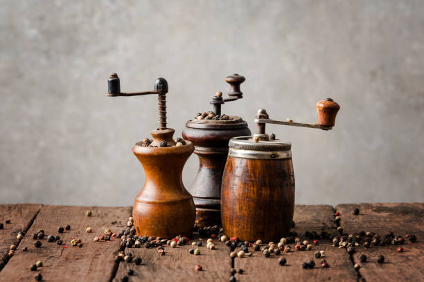 istock Vintage wooden pepper mills with peppercorns 1305951582